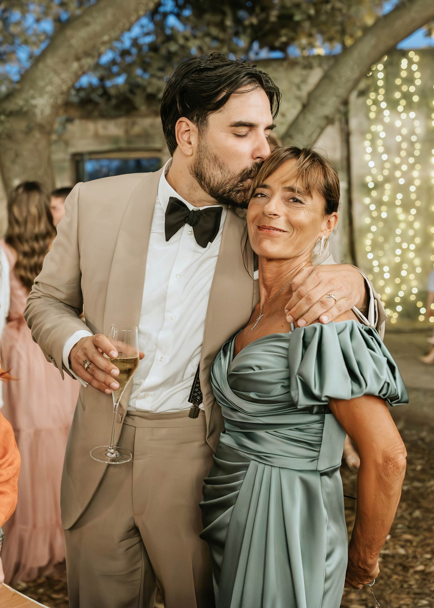 Un momento speciale tra Simone e sua madre: l’eleganza del suo abito su misura incontra l’affetto familiare.